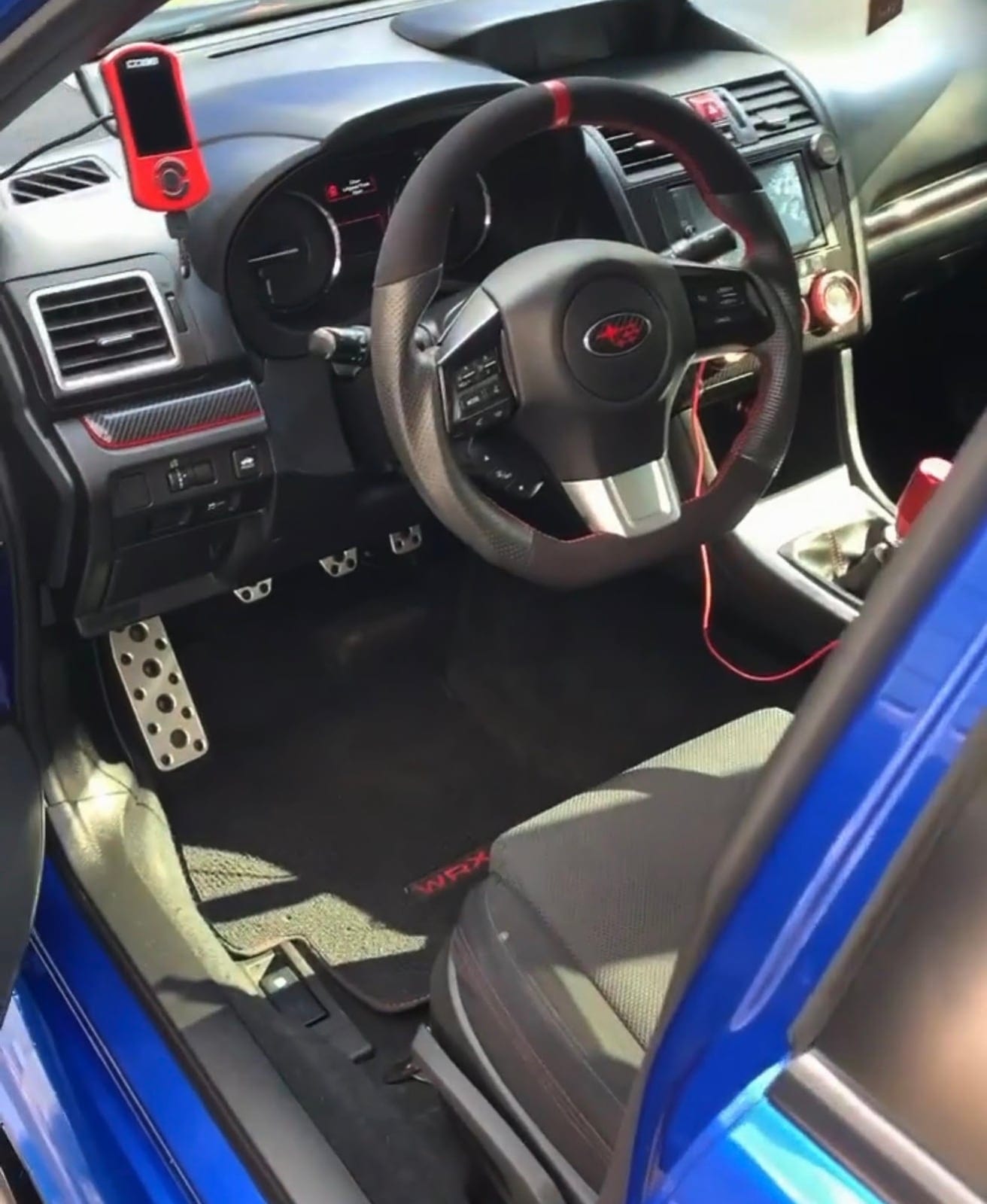 The detailed driver's seat and dash of a Subaru WRX